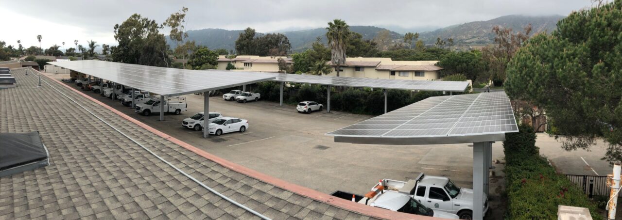View overlooking parking lot from office roof, showing solar panel canopies.
